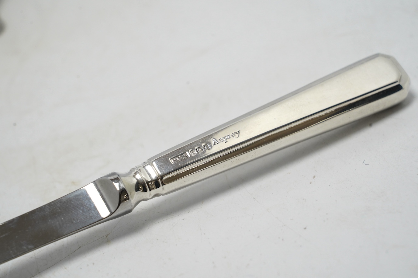 A late Victorian novelty propelling pencil modelled as two coins mounted on a central boss, diameter 24mm, together with a small late Victorian silver whistle, mounted scent flask, silver thimble and a modern Asprey silv